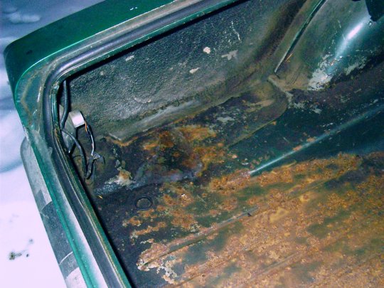Rust on the driver's side of the trunk floor